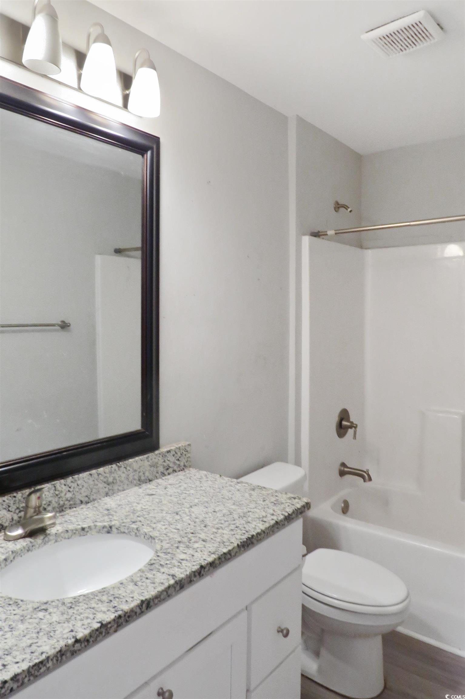 204 Rosedale Drive Aynor, SC 29511 - Photo 19 of 23 Bathroom featuring vanity, bathtub / shower combination, and wood finished floors