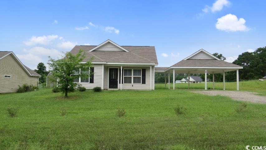 204 Rosedale Drive Aynor, SC 29511 - Photo 2 of 23 Front view of house featuring a lawn, driveway, and a shingled roof.