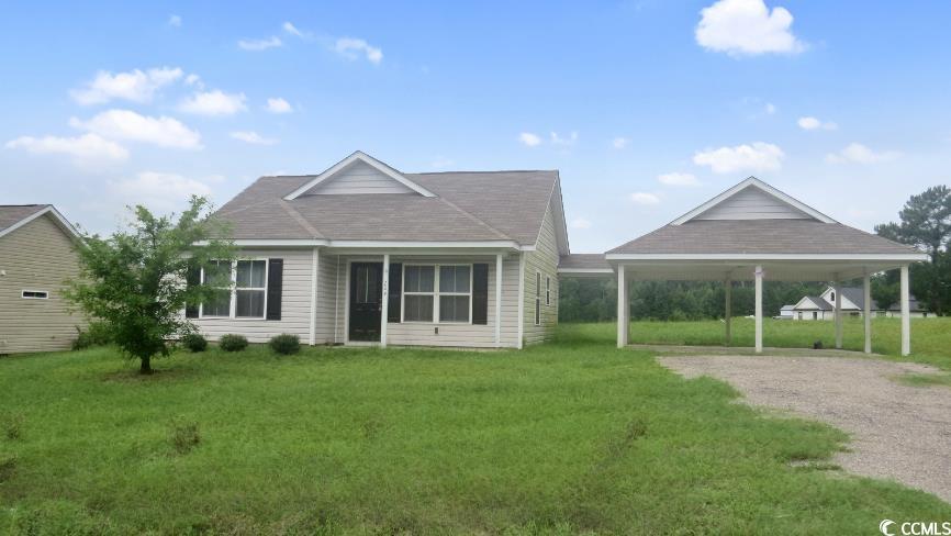204 Rosedale Drive Aynor, SC 29511 - Photo 3 of 23 View of front of property with gravel driveway, a carport, a front yard, and a shingled roof.