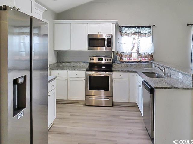 204 Rosedale Drive Aynor, SC 29511 - Photo 4 of 23 Kitchen featuring appliances with stainless steel finishes, lofted ceiling, white cabinets, and a peninsula
