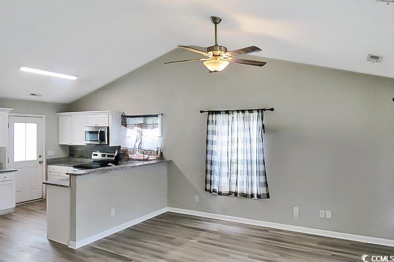 204 Rosedale Drive Aynor, SC 29511 - Photo 8 of 23 Kitchen with white cabinetry, stainless steel microwave, wood finished floors, ceiling fan, and range with electric cooktop