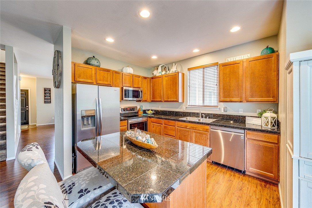 288 East Fulton Way Bremerton, WA 98310 - Photo 5 of 25 a kitchen with stainless steel appliances granite countertop a refrigerator a sink a stove and island