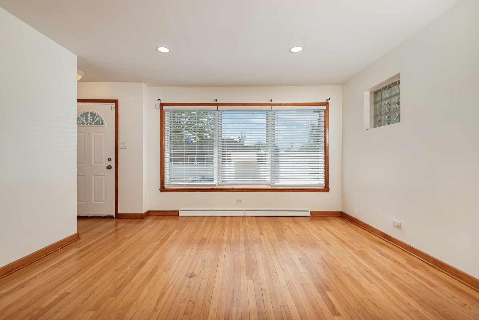 7004 West Foster Avenue Chicago, IL 60656 - Photo 2 of 16 a view of an empty room with wooden floor and a window