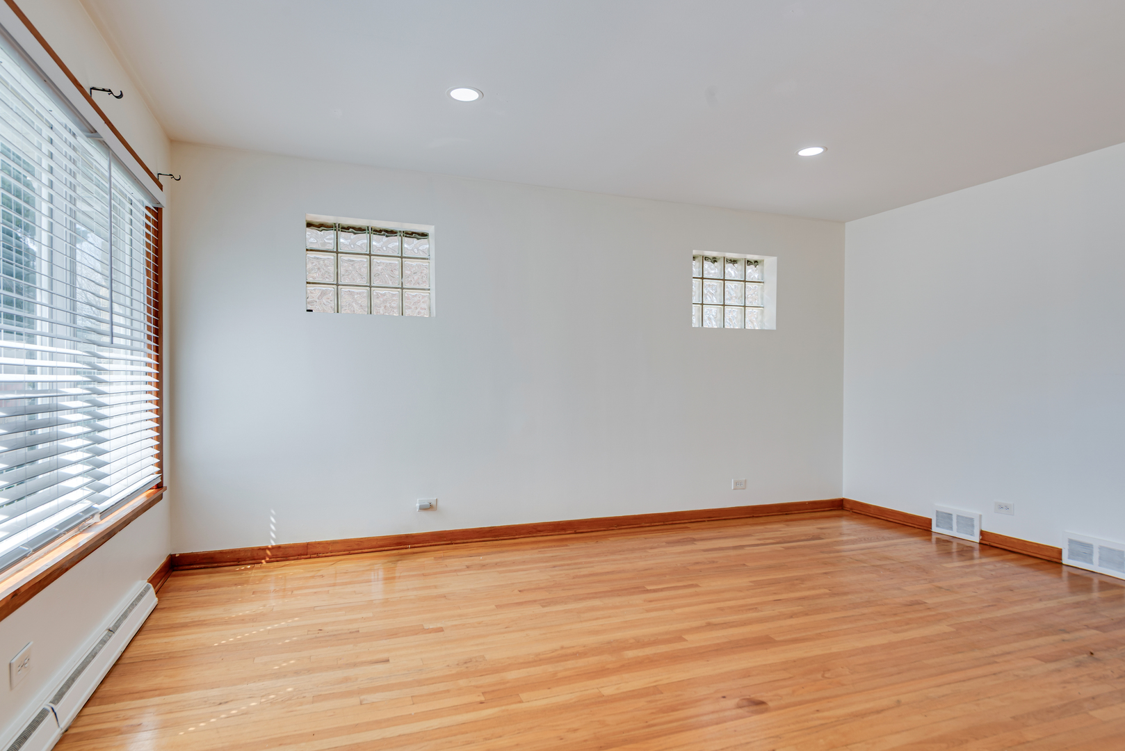 7004 West Foster Avenue Chicago, IL 60656 - Photo 3 of 16 a view of an empty room with wooden floor and a window
