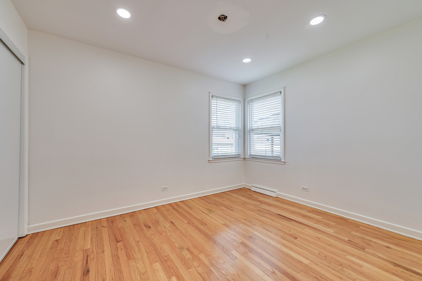 7004 West Foster Avenue Chicago, IL 60656 - Photo 9 of 16 an empty room with wooden floor and windows