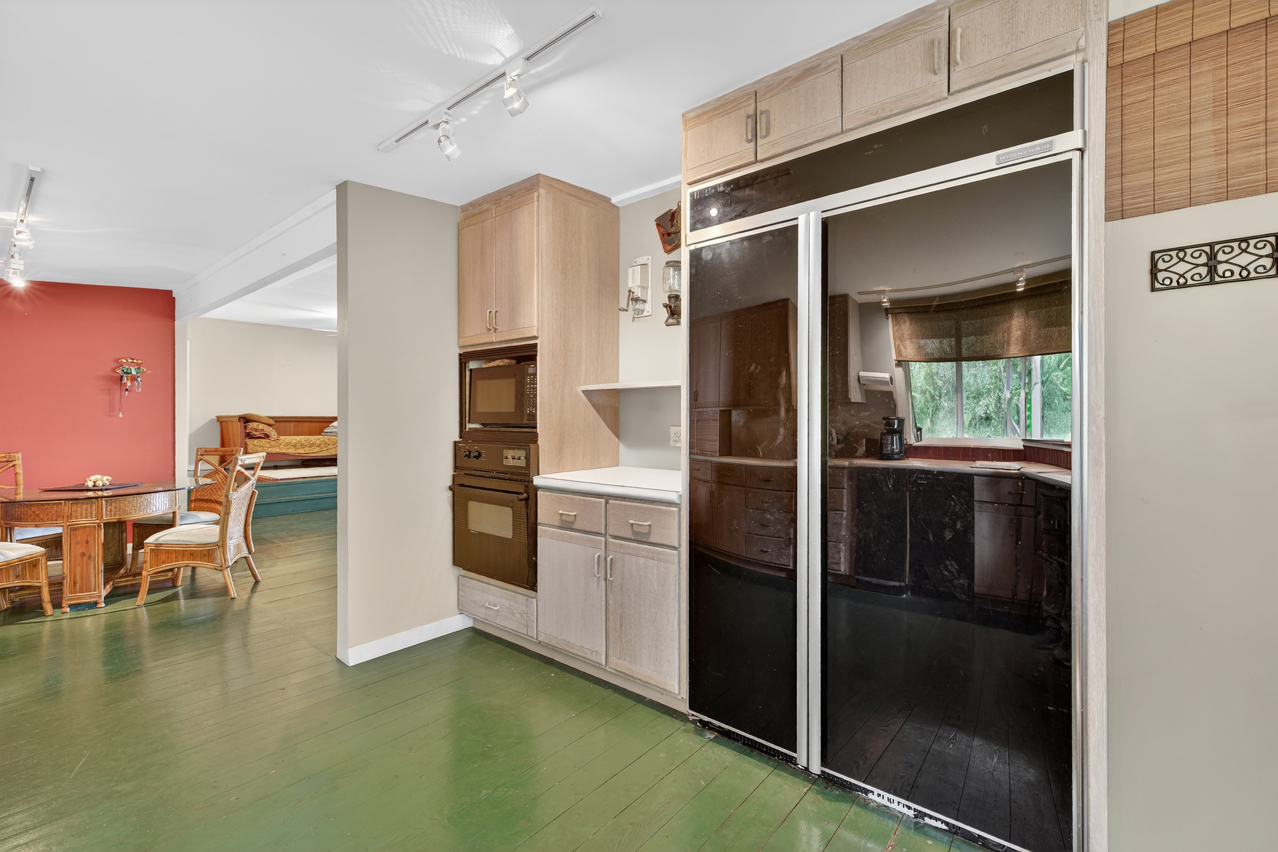 83-5531 Hawaii Belt Road Captain Cook, HI 96704 - Photo 11 of 30 a kitchen with a refrigerator and white cabinets