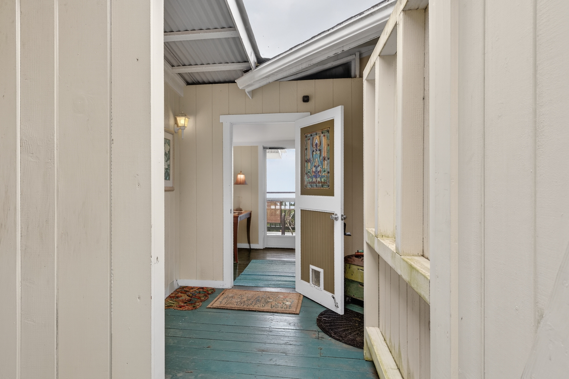 83-5531 Hawaii Belt Road Captain Cook, HI 96704 - Photo 19 of 30 a hallway with a view of bedroom with wooden floor