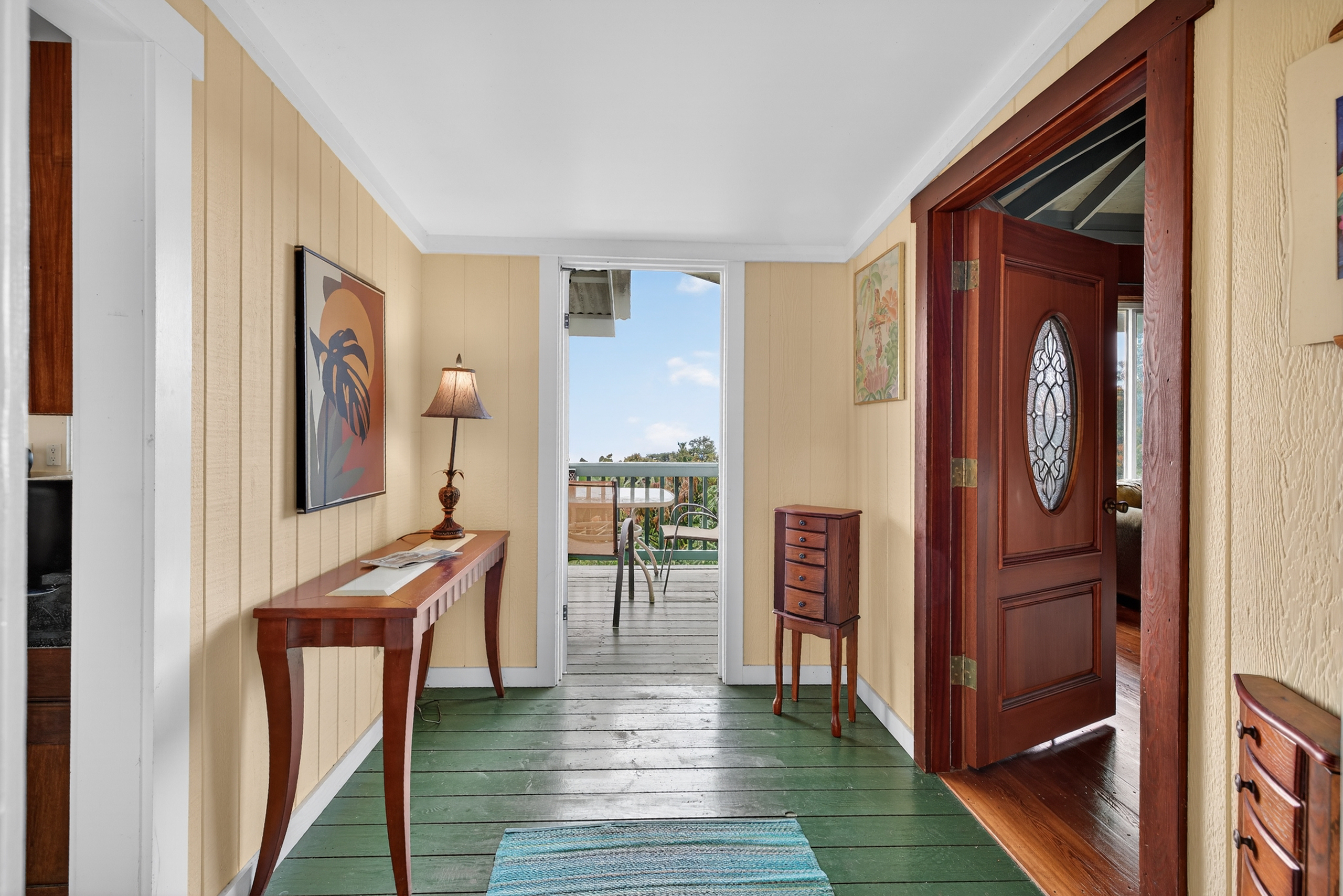 83-5531 Hawaii Belt Road Captain Cook, HI 96704 - Photo 20 of 30 a view of a hallway with wooden floor windows and a livingroom