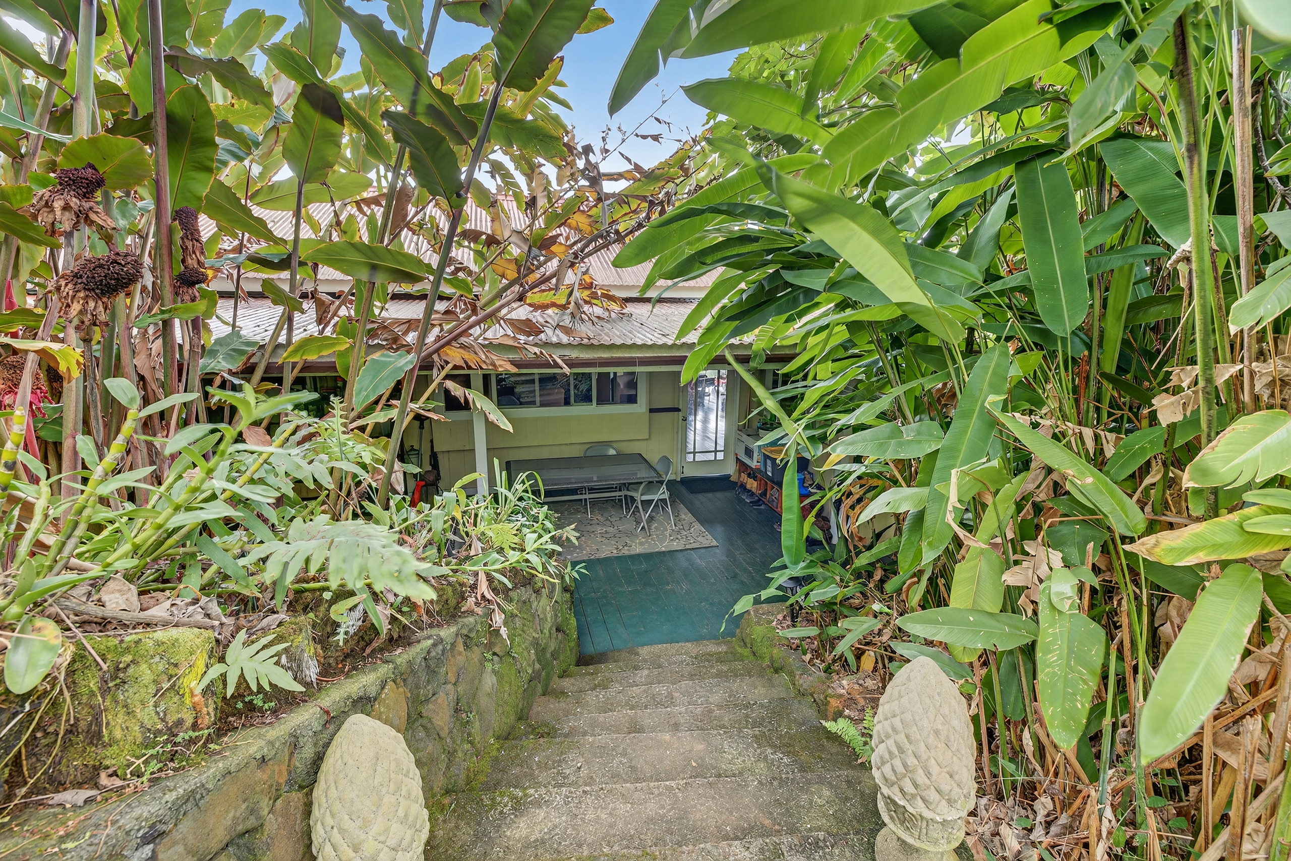 83-5531 Hawaii Belt Road Captain Cook, HI 96704 - Photo 2 of 30 a backyard of a house with outdoor seating