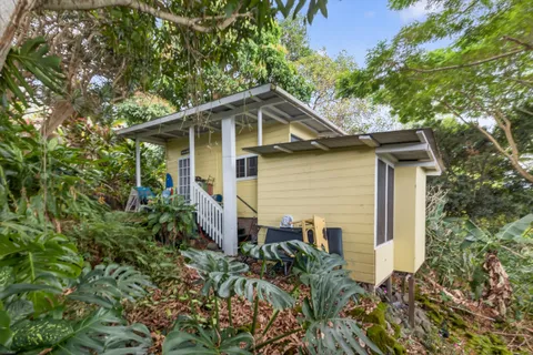 a aerial view of a house with a yard table and chairs