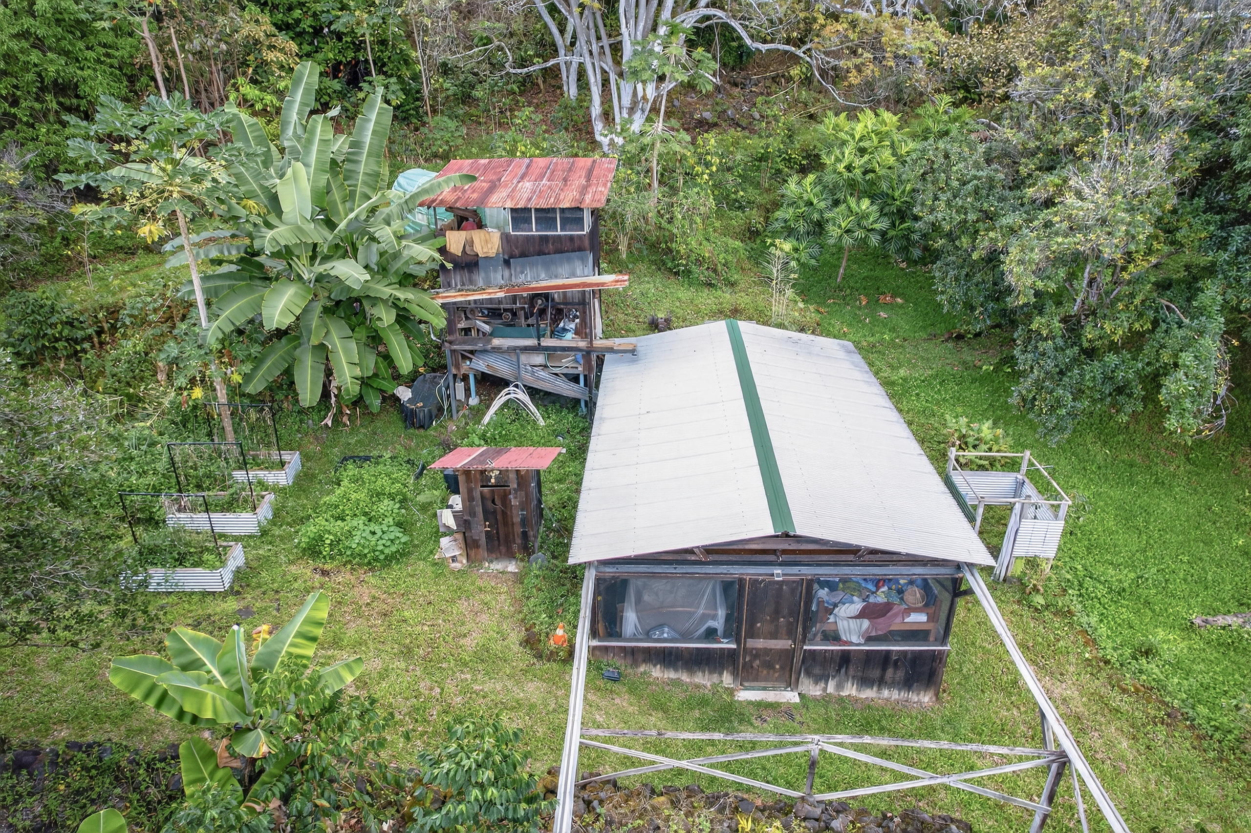 83-5531 Hawaii Belt Road Captain Cook, HI 96704 - Photo 30 of 30 a aerial view of a house with a yard table and chairs