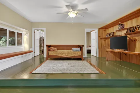 a dining room with furniture and a floor to ceiling window