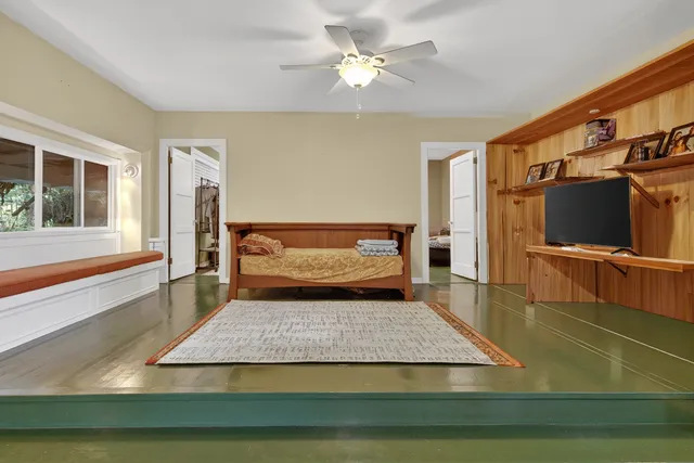 a dining room with furniture and a floor to ceiling window