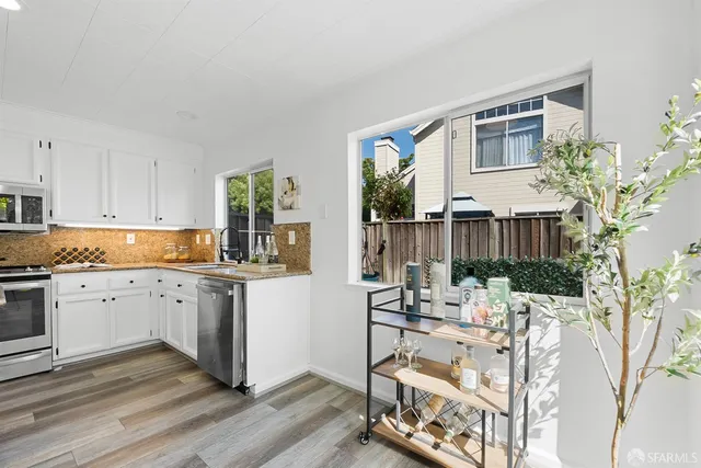 a kitchen with sink cabinets and stove