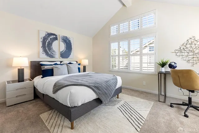 a bedroom with a bed a dresser and chair