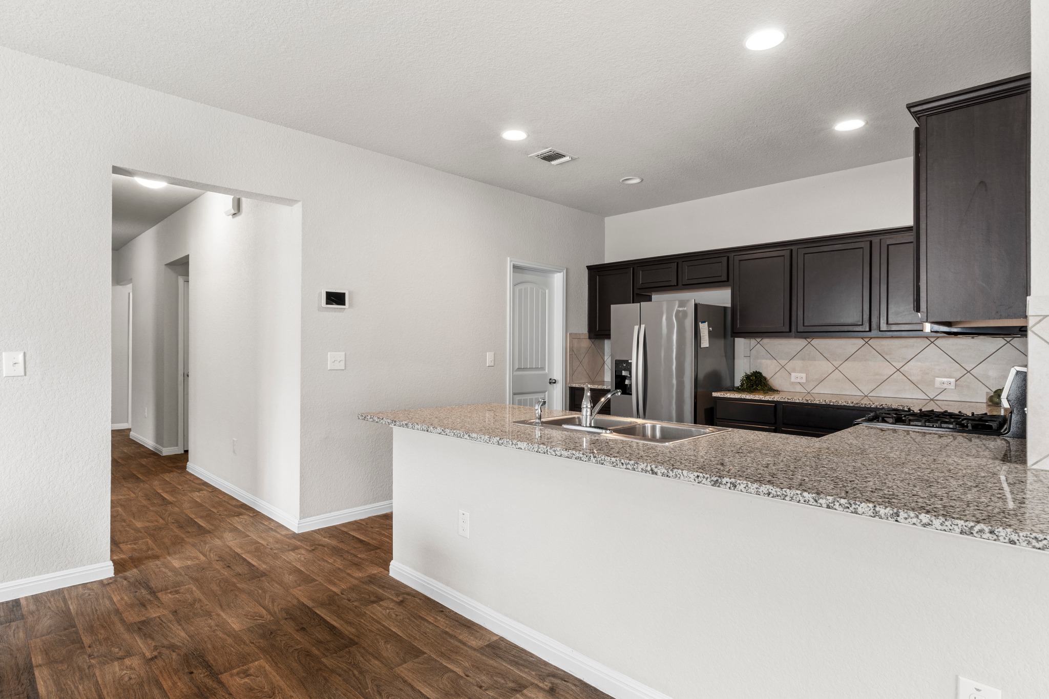 10809 Gonzales Ranger Pass Austin, TX 78754 - Photo 12 of 37 The oversized kitchen peninsula offers space for bar seating, perfect for casual dining and entertaining.