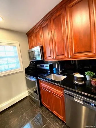 a kitchen with granite countertop cabinets and window