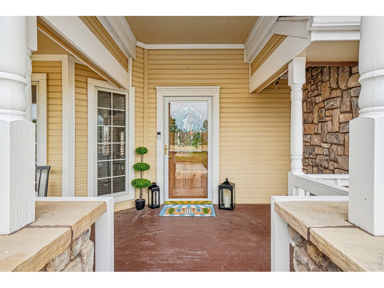 9743 Yellowstone Road Longmont, CO 80504 - Photo 9 of 50 The private covered front porch is a welcoming entry to this beautiful property