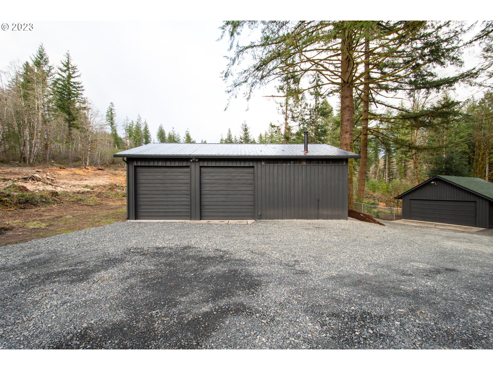 28013 Northeast Falls Road Yacolt, WA 98675 - Photo 3 of 43 a front view of a house with a yard and garage