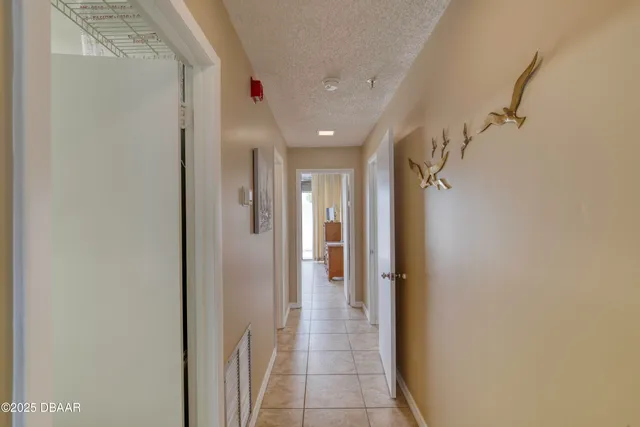 a view of a livingroom with furniture and a hallway