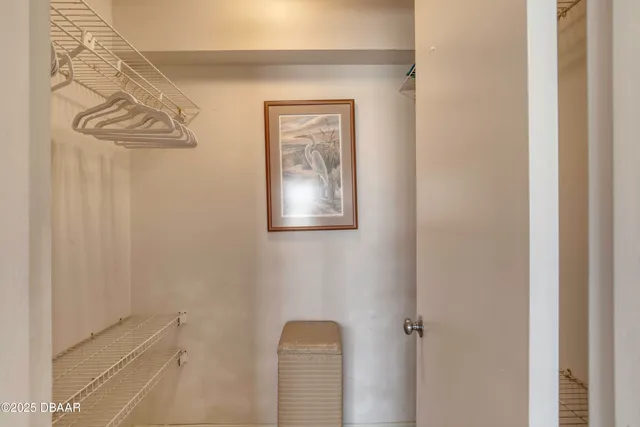 a bedroom with a bed and a flat tv screen on dresser