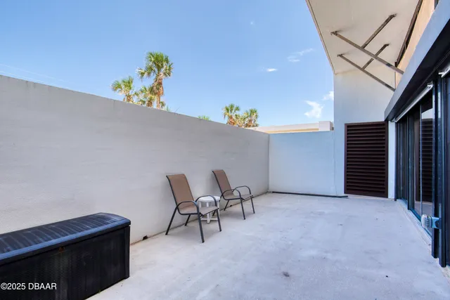 a view of swimming pool with seating space and yard in back
