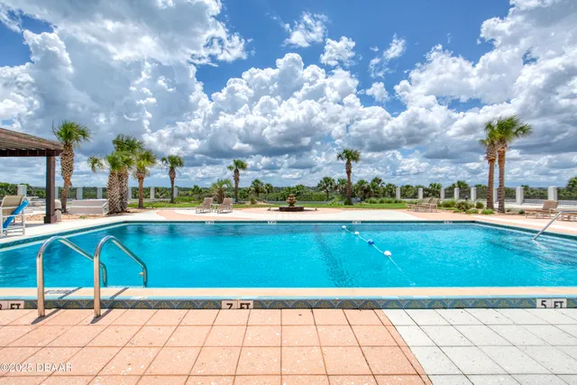 a living room with furniture and potted plant