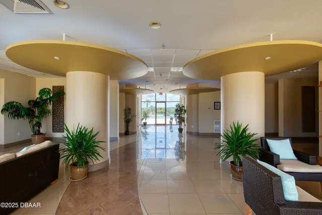 a living room with furniture potted plant and a potted plant