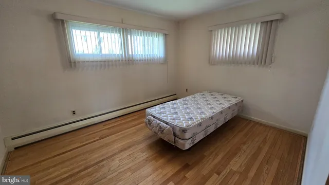 a room with a bed and window