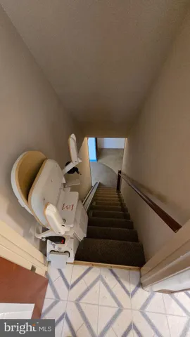 a hallway with chairs and a wooden floor