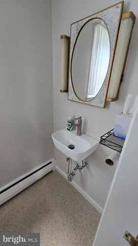 a white toilet sitting next to a bathroom sink