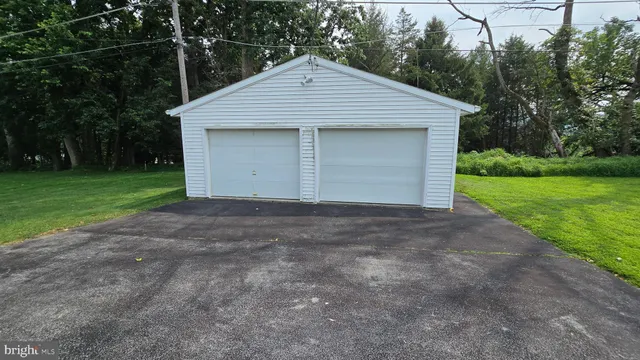 a front view of a house with yard and garage