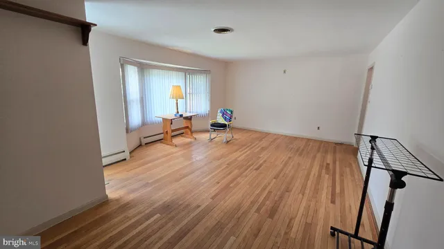 a room with wooden floor and furniture