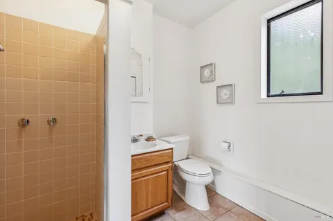 a white toilet sitting next to a bathroom sink