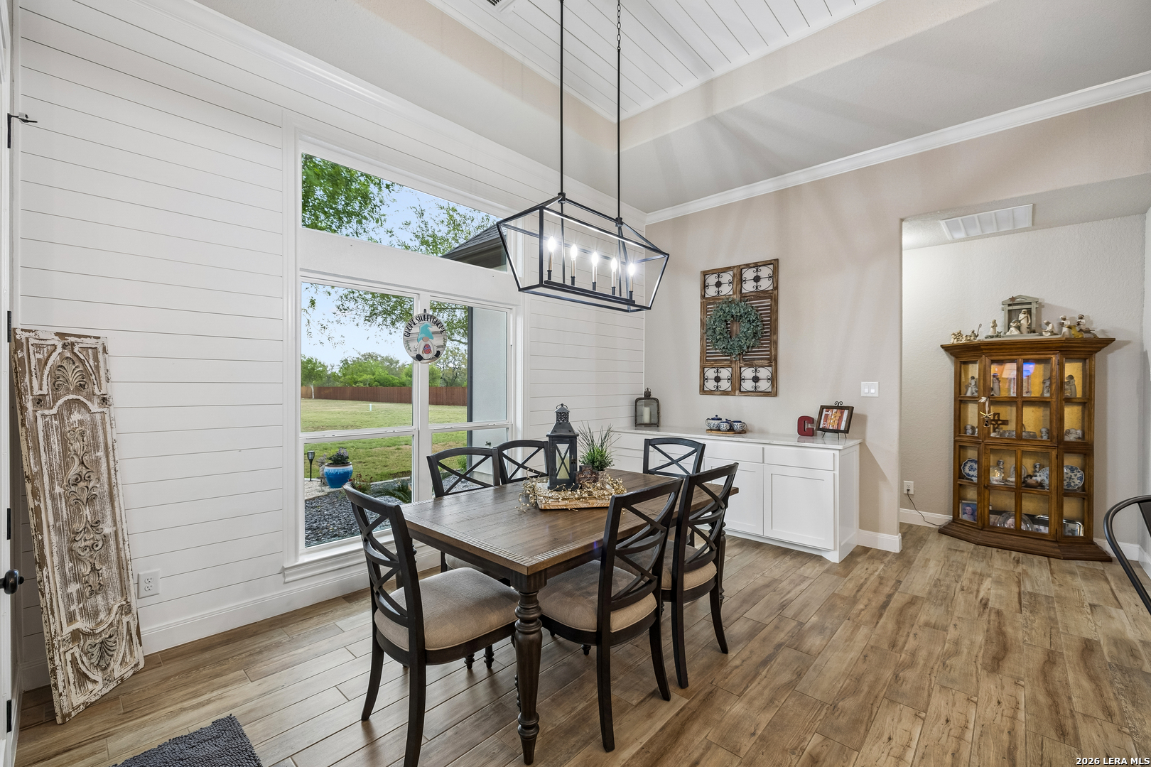 498 Double Gate Road Castroville, TX 78009 - Photo 12 of 28 a dining room with furniture a chandelier and wooden floor
