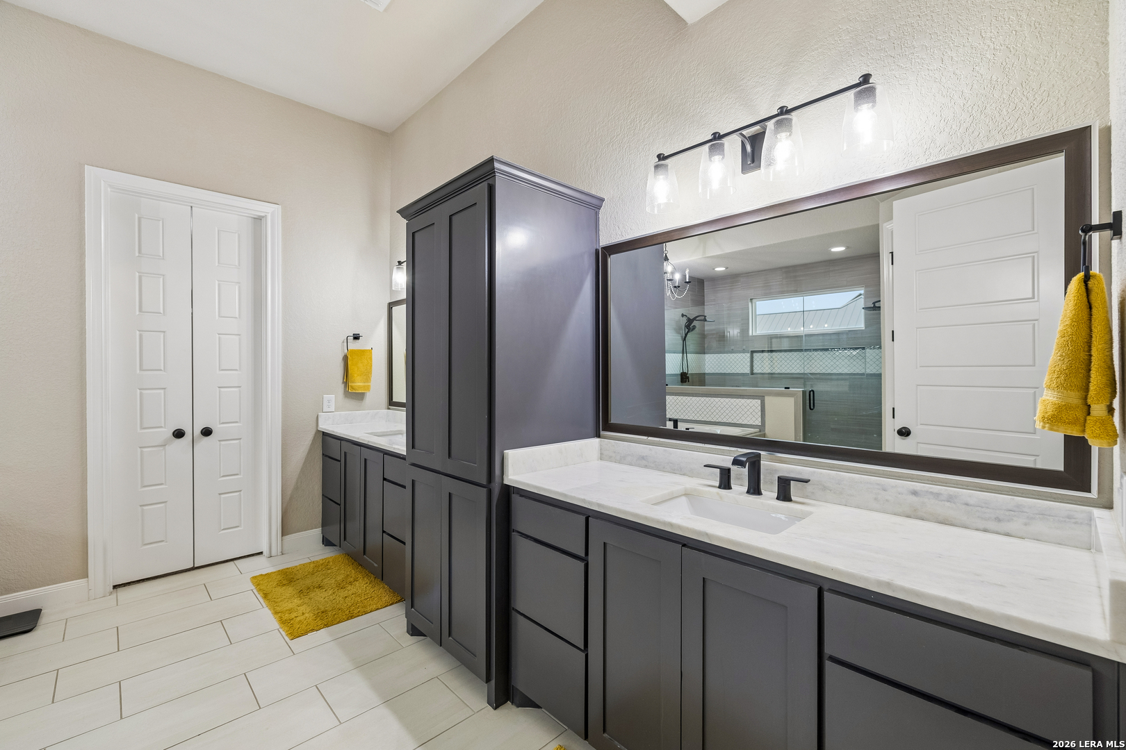 498 Double Gate Road Castroville, TX 78009 - Photo 14 of 28 a spacious bathroom with a sink and a mirror