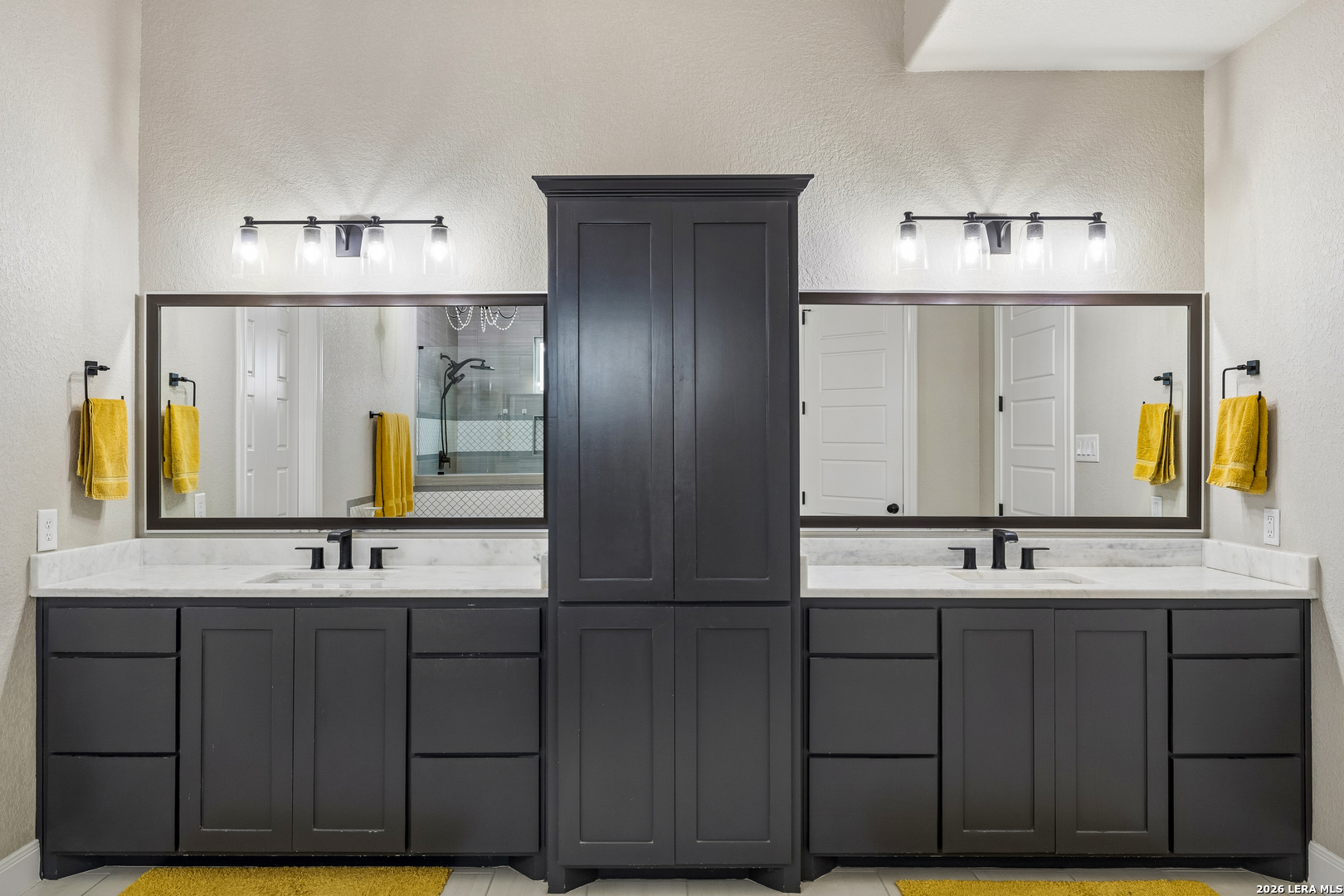 498 Double Gate Road Castroville, TX 78009 - Photo 15 of 28 a bathroom with a double vanity sink and a mirror