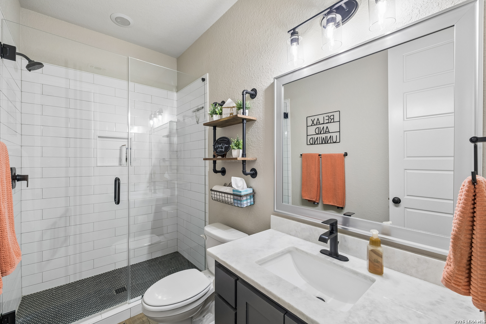 498 Double Gate Road Castroville, TX 78009 - Photo 18 of 28 a bathroom with a sink toilet and shower