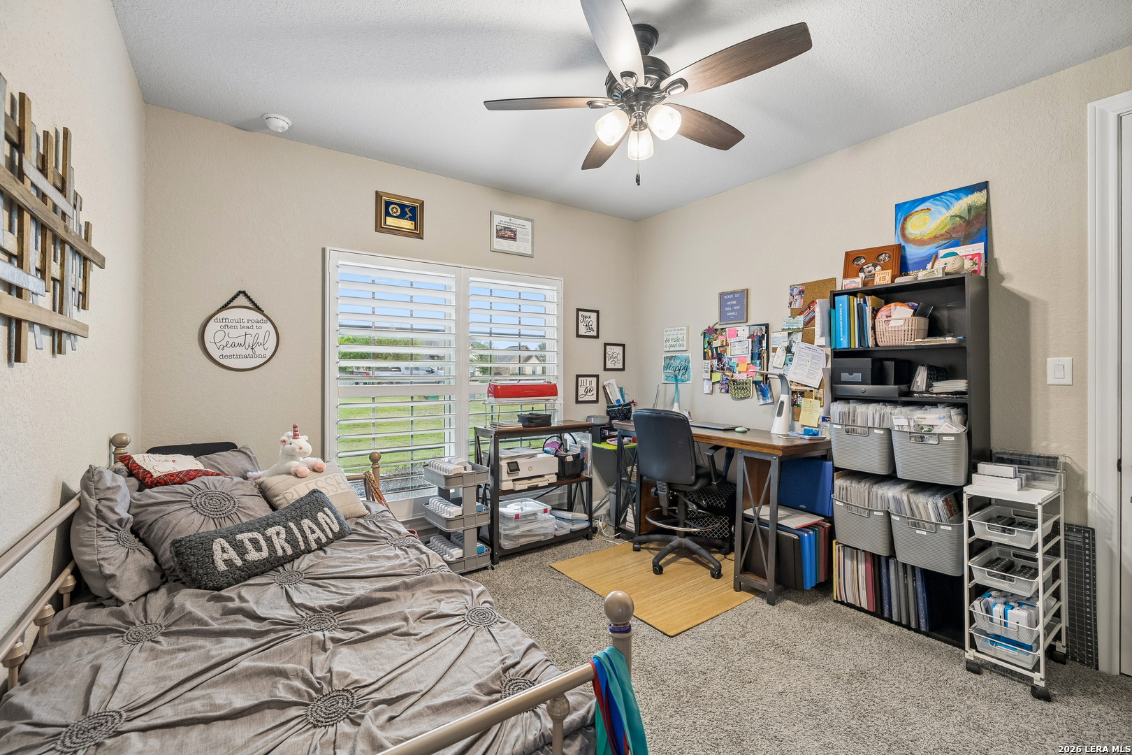 498 Double Gate Road Castroville, TX 78009 - Photo 19 of 28 a bedroom that has a bed and a bookshelf in it