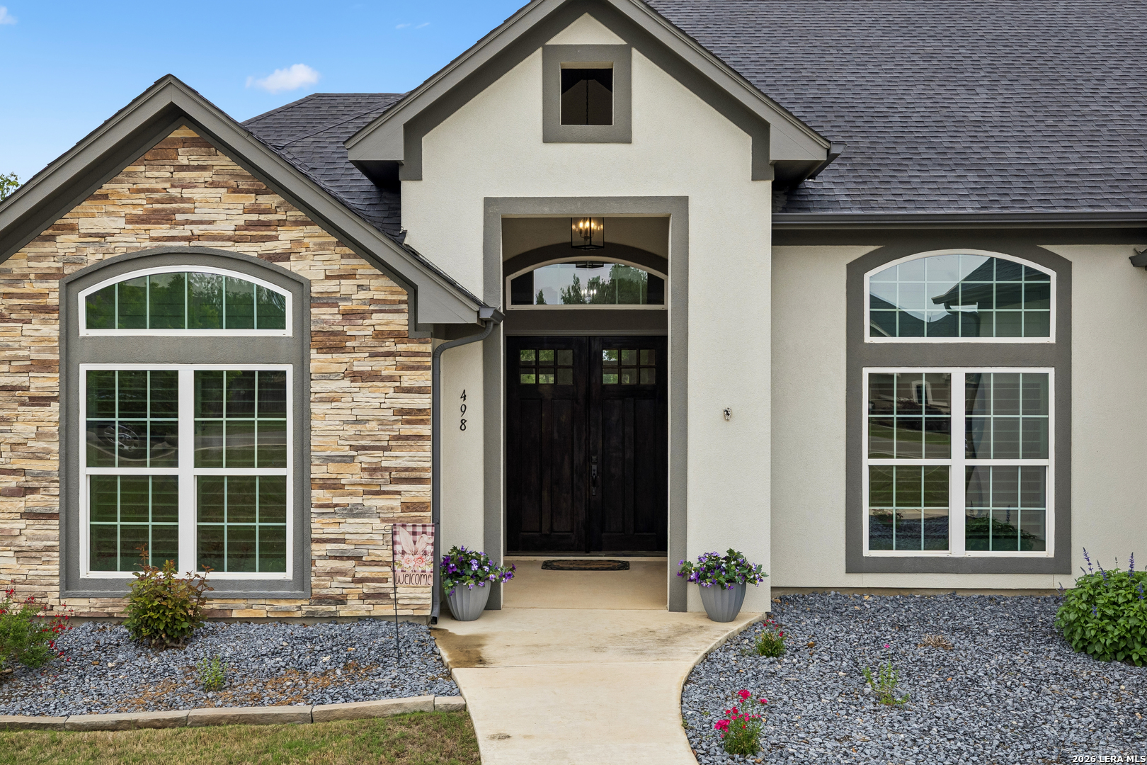 498 Double Gate Road Castroville, TX 78009 - Photo 2 of 28 a front view of a house with garden