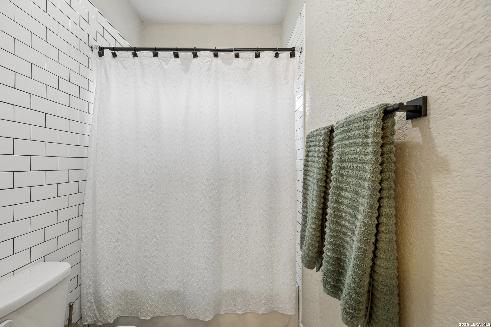 498 Double Gate Road Castroville, TX 78009 - Photo 21 of 28 a close up of a shower curtain