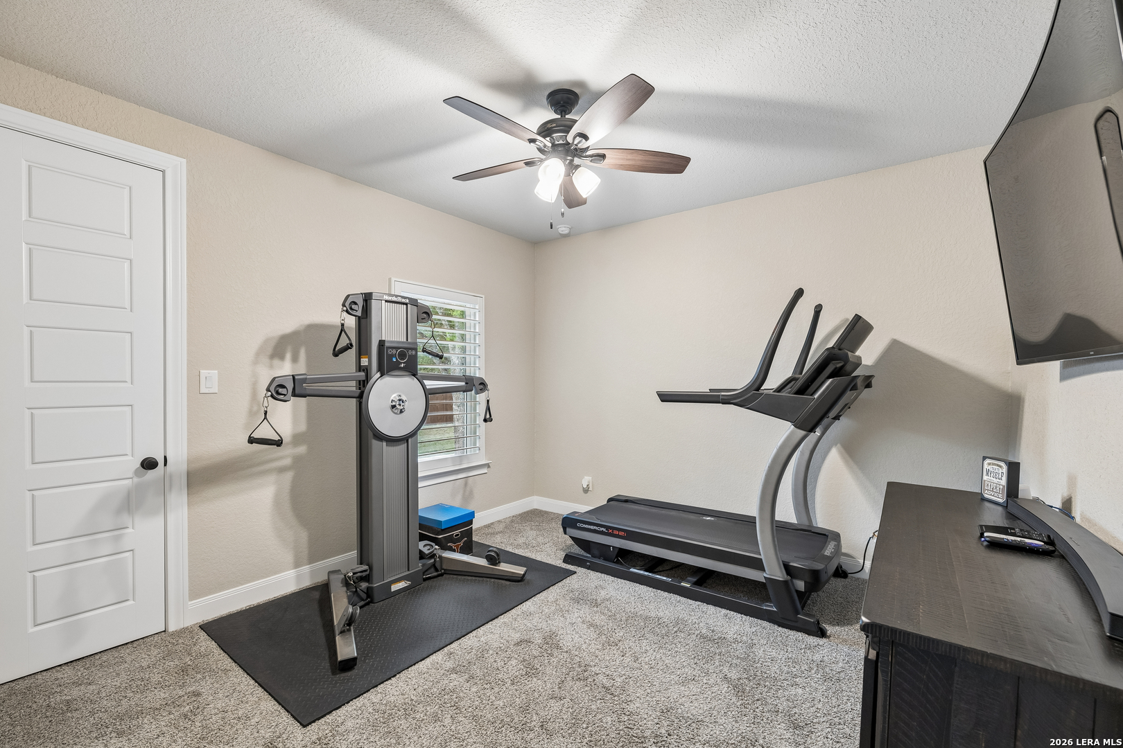 498 Double Gate Road Castroville, TX 78009 - Photo 22 of 28 a room with gym equipment and mirror