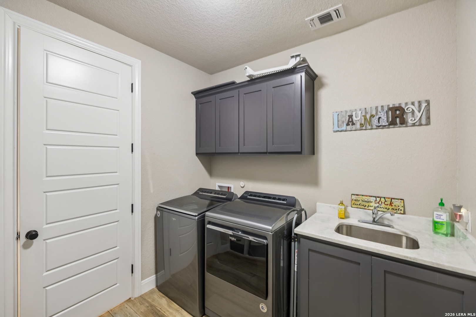498 Double Gate Road Castroville, TX 78009 - Photo 23 of 28 a utility room with sink dryer and washer