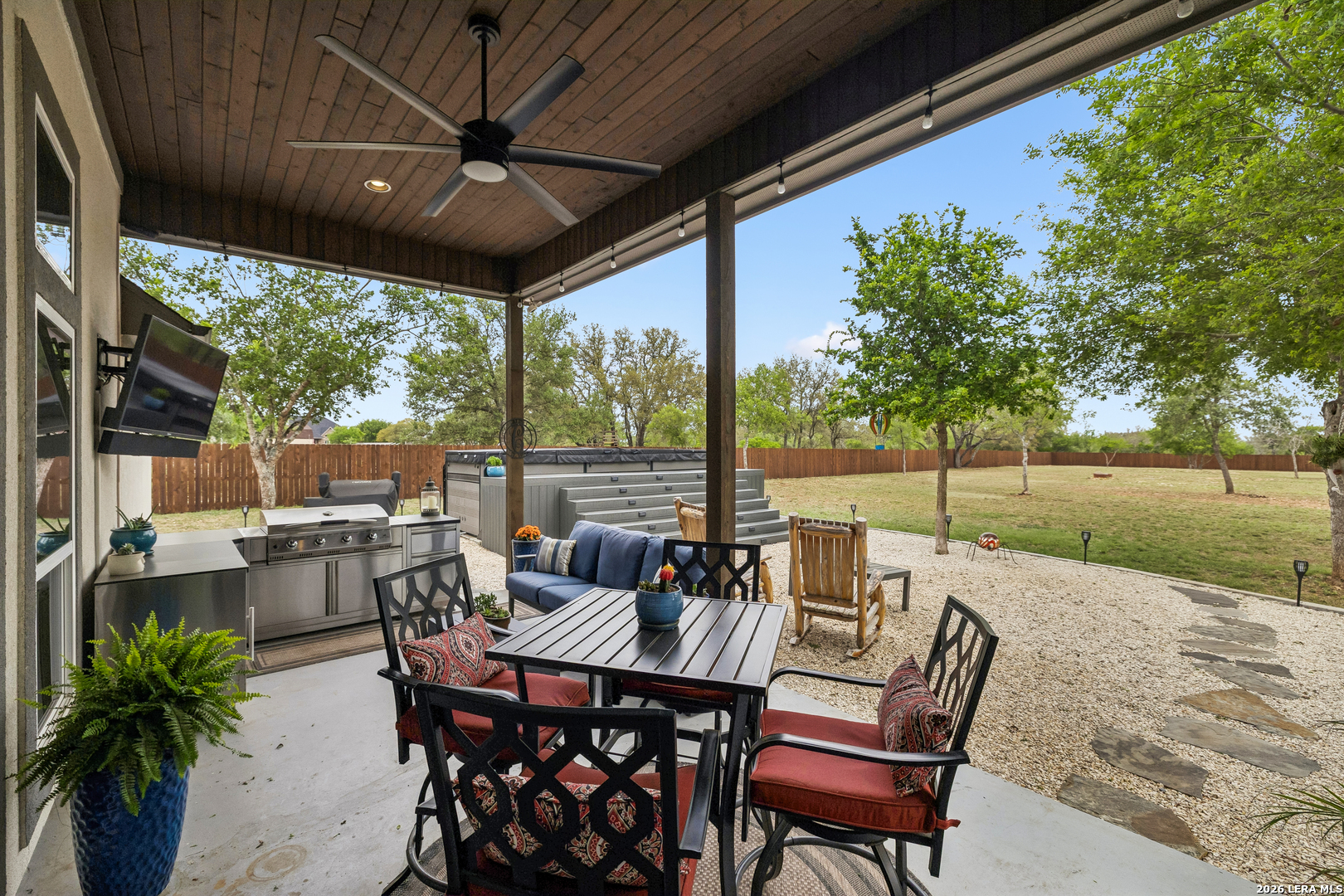 498 Double Gate Road Castroville, TX 78009 - Photo 24 of 28 a view of an outdoor dining space with a table and chairs