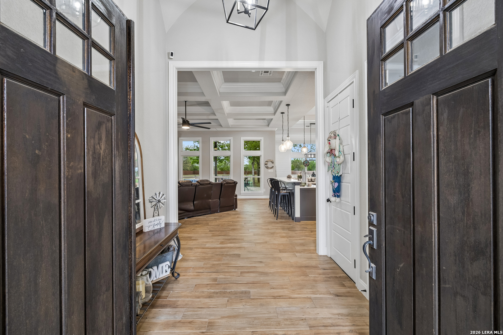 498 Double Gate Road Castroville, TX 78009 - Photo 3 of 28 a view of a hallway with wooden floor and a living room
