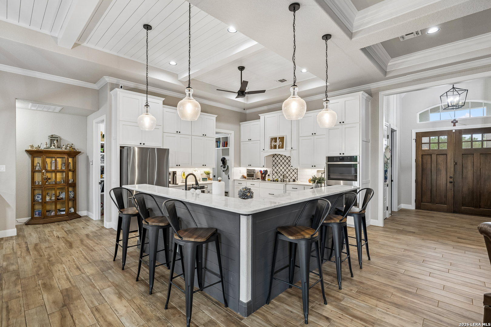 498 Double Gate Road Castroville, TX 78009 - Photo 9 of 28 a large kitchen with a table and chairs