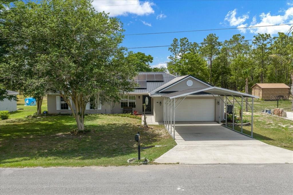 234 Locust Lane Ocala, FL 34472 - Photo 1 of 71 a white house that has a tree in front of it