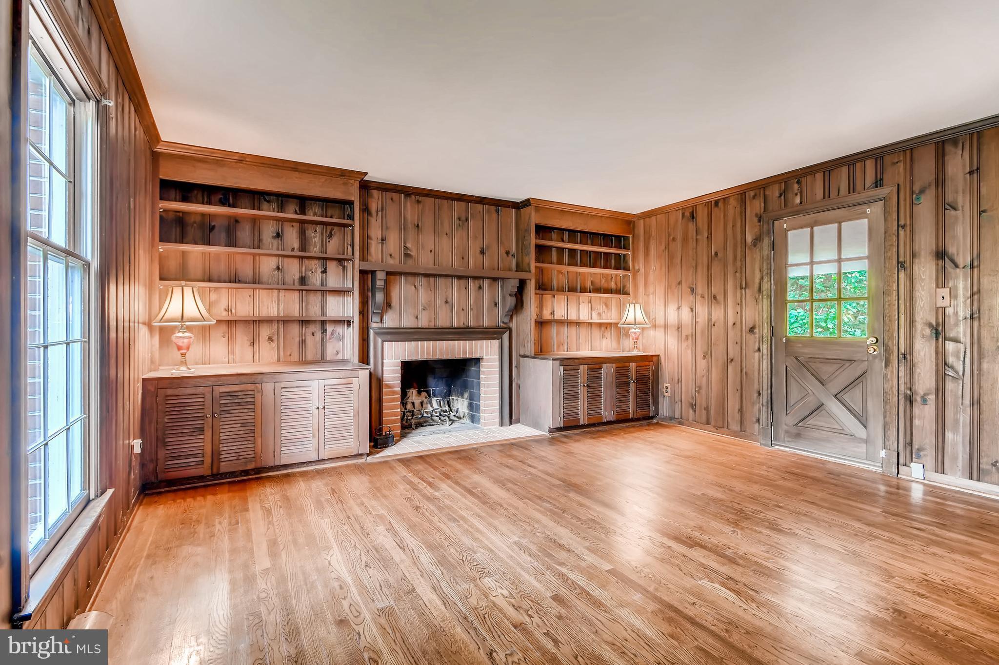 7835 Ellenham Road Baltimore, MD 21204 - Photo 13 of 22 Cozy paneled den with wood burning fireplace.