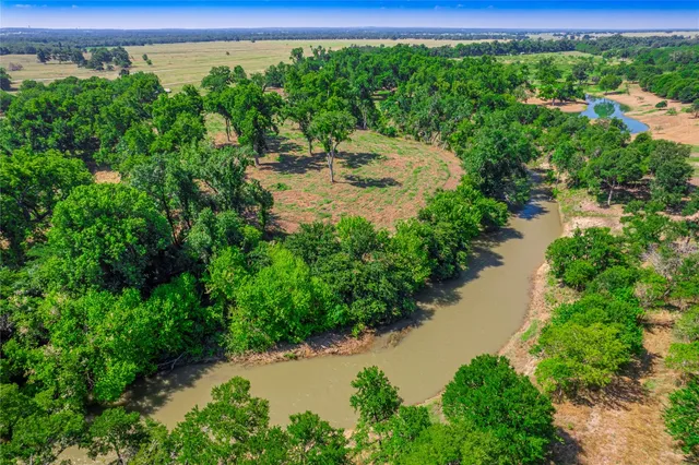 a view of a lake with a yard from a balcony