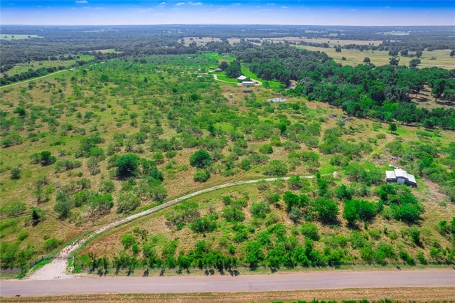 a view of a green field with an outdoor space